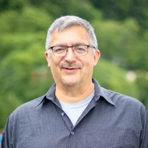 A headshot of Charles Edwardson smiling for the camera.