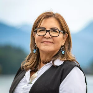 A headshot of Jodi Mitchell, wearing glasses and smiling with lips closed.