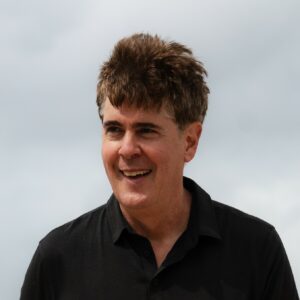 A headshot of Terry Downes smiling for the camera.